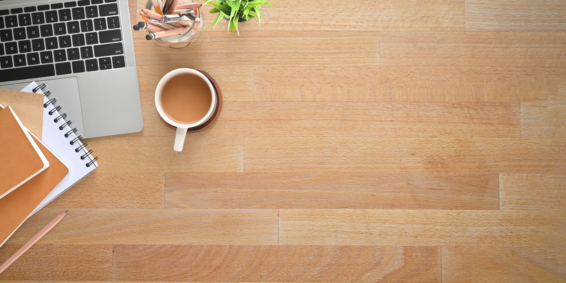 Top View Wooden Office Desk with Coffee, Computer Laptop, Notebooks